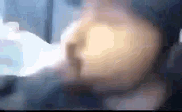 a blurry picture of a person 's face with a light coming out of it