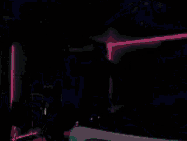 a pixelated image of a man in a room with a neon sign that says p