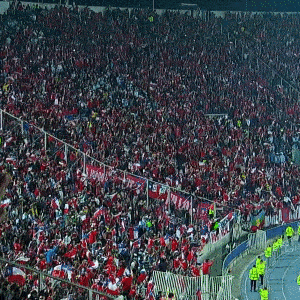 a large crowd of people in a stadium with a sign that says www on it