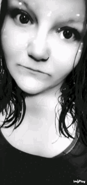 a woman 's face is shown in a black and white photo