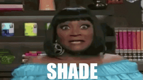 a woman is wearing a blue off the shoulder top with the word shade on it
