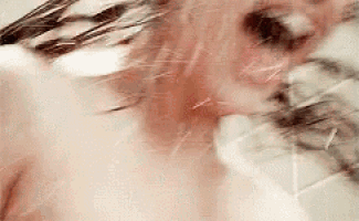 a woman is taking a bath in a bathtub with a cat .