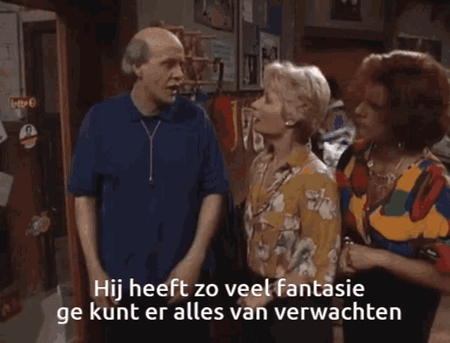 a man and two women standing next to each other with a caption that says hij heeft