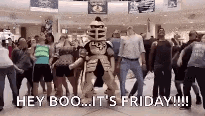 a mascot in a knight costume is dancing in front of a crowd of people in a mall .