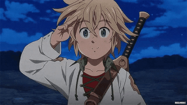 a young boy is holding a sword in his hand and giving a peace sign .
