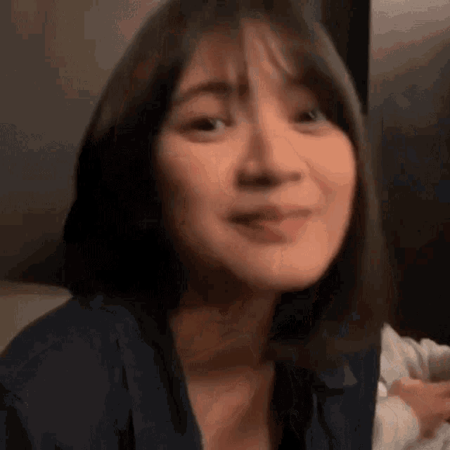 a close up of a woman 's face with a blurred background .