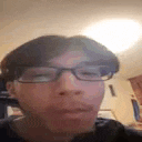 a man wearing glasses is making a funny face .