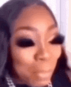 a close up of a woman 's face with black eyeshadow on .