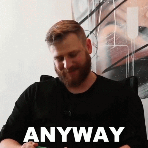 a man with a beard is wearing a black shirt that says anyway on it