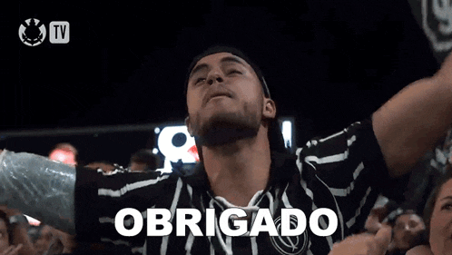 a man in a black and white shirt with the word obrigado written on it