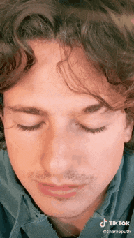 a close up of a person 's face with their eyes closed