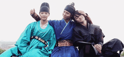 three people in traditional korean costumes are posing for a picture