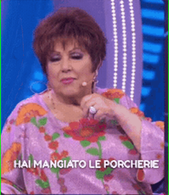 a woman in a purple dress with the words hai mangiato le porcherie