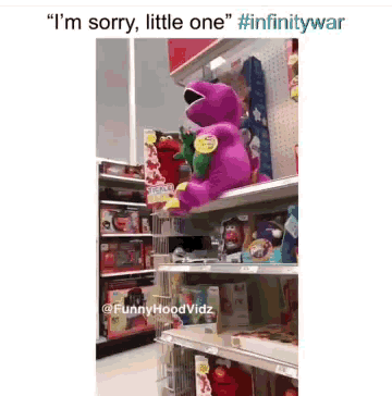 a purple teddy bear is sitting on a shelf in a store