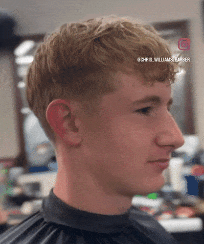a young man getting his hair cut by chris williams