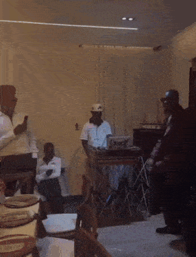 a group of people standing around a table with a laptop that says boost