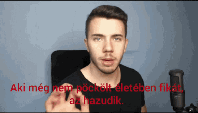 a man in a black shirt stands in front of a microphone with the words aki meg nem pockolt eleteben fikat az hazudik