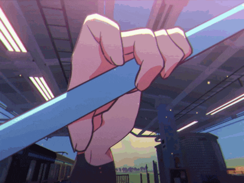a person 's hand is holding a blue railing in a train station