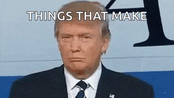 donald trump is wearing a suit and tie while making a funny face .