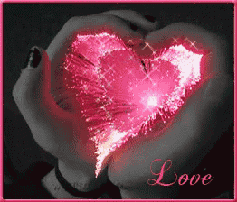 a woman is holding a pink heart in her hands with the word love written below it