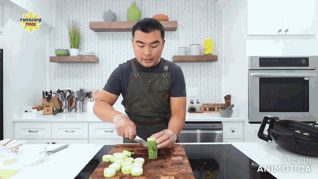 a man is cutting vegetables in a kitchen with a panlasang pinoy logo on the wall behind him