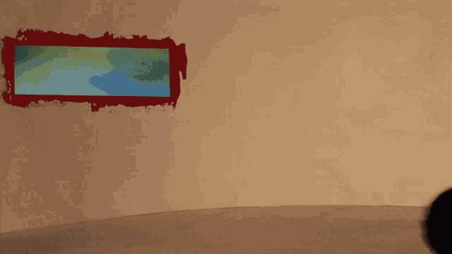 a shadow of a ball is cast on a wall with a red and green stripe