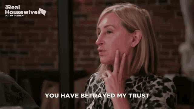 a woman says " you have betrayed my trust " in front of a brick wall