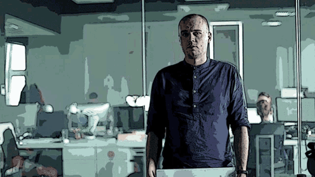 a man in a blue shirt is standing in front of a glass wall