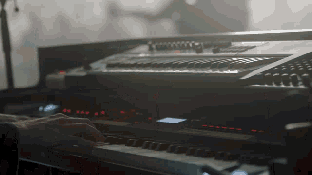 a close up of a person playing a keyboard with a few numbers on it