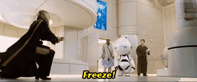 a group of people standing around a robot that says freeze on it