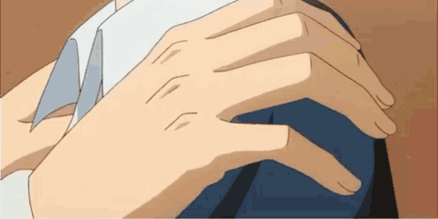 a close up of a person 's hands on a blue shirt