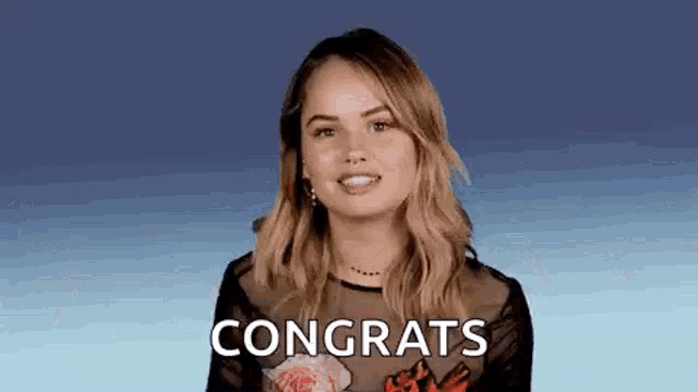 a woman is congratulating another woman with a congratulations gif .