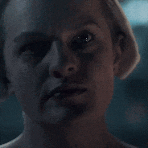 a close up of a woman 's face with a serious look on her face