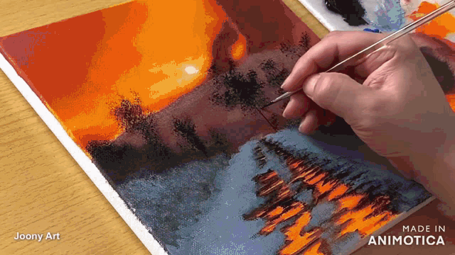 a person is painting a picture with the words made in animatica on the bottom right