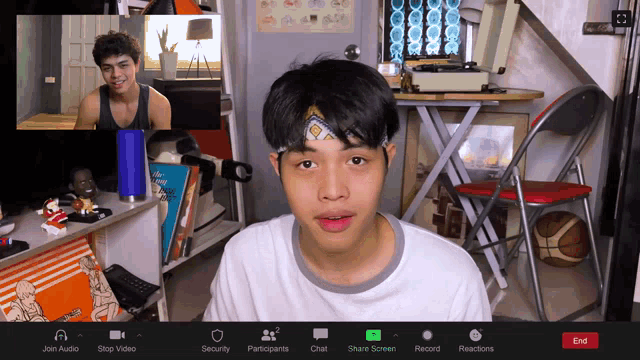 a screen shot of a video call shows a man wearing a headband