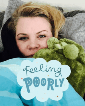 a woman is laying on a couch with a stuffed animal and a sign that says feeling poorly