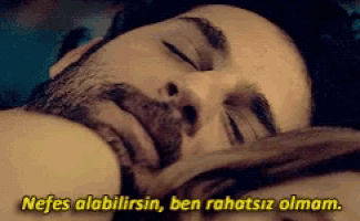 a man with a beard is sleeping next to a woman with the words nefes alabilirim ben rahatsiz olmam on the bottom