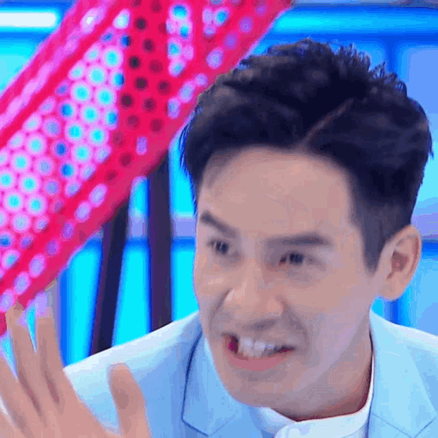 a close up of a man making a funny face with his mouth open