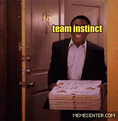 a man in a suit is carrying a stack of pizza boxes with the caption " team instinct "