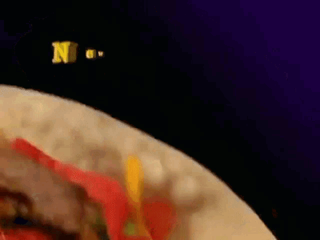 a close up of a plate of food with the word new written on it .