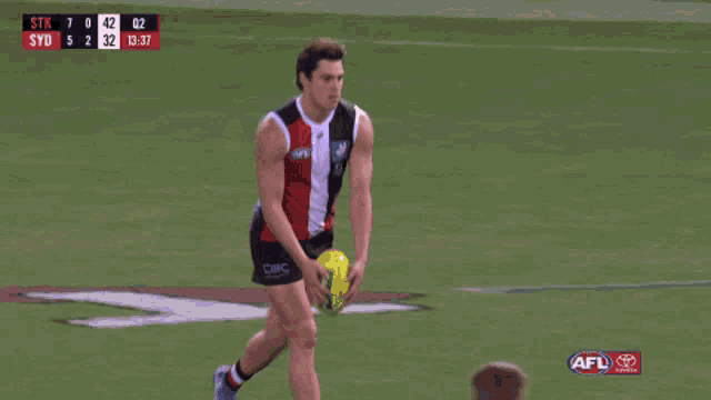 a man in an afl jersey is pointing at the camera