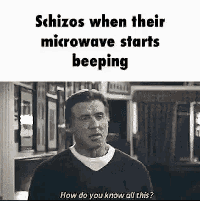 a man is standing in front of a microwave and talking to it .