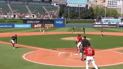 a baseball game is being played in front of progressive and meijer ads