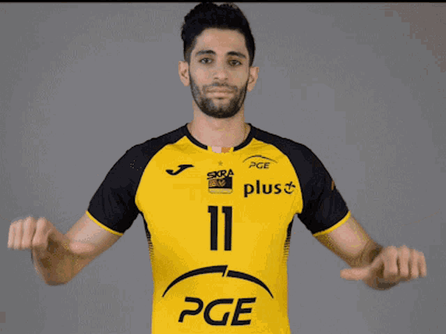 a man wearing a yellow and black pge jersey