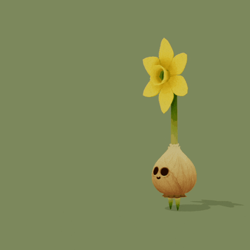 a yellow flower and an onion on a green surface