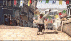 a man is riding a bike down a street with flags hanging from the buildings