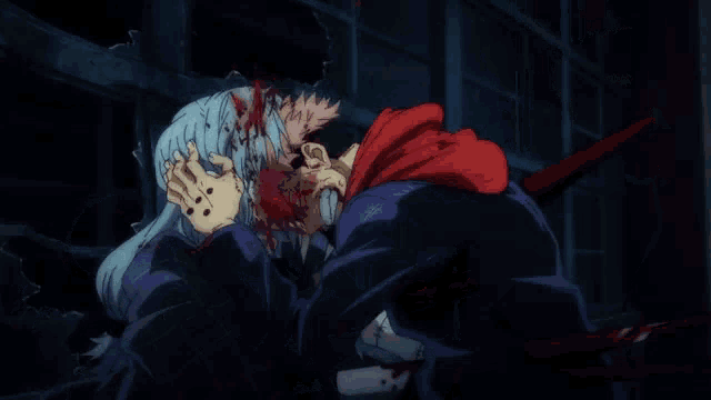 a man in a red hoodie holds a woman 's head