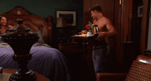 a man and a woman are sitting on a bed