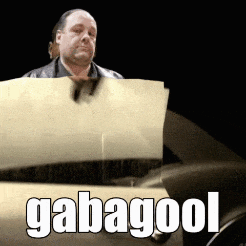 a man is holding a piece of paper with the word gabagool on it