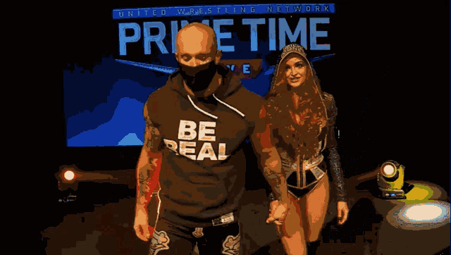 a man and woman are walking in front of a sign that says home time live